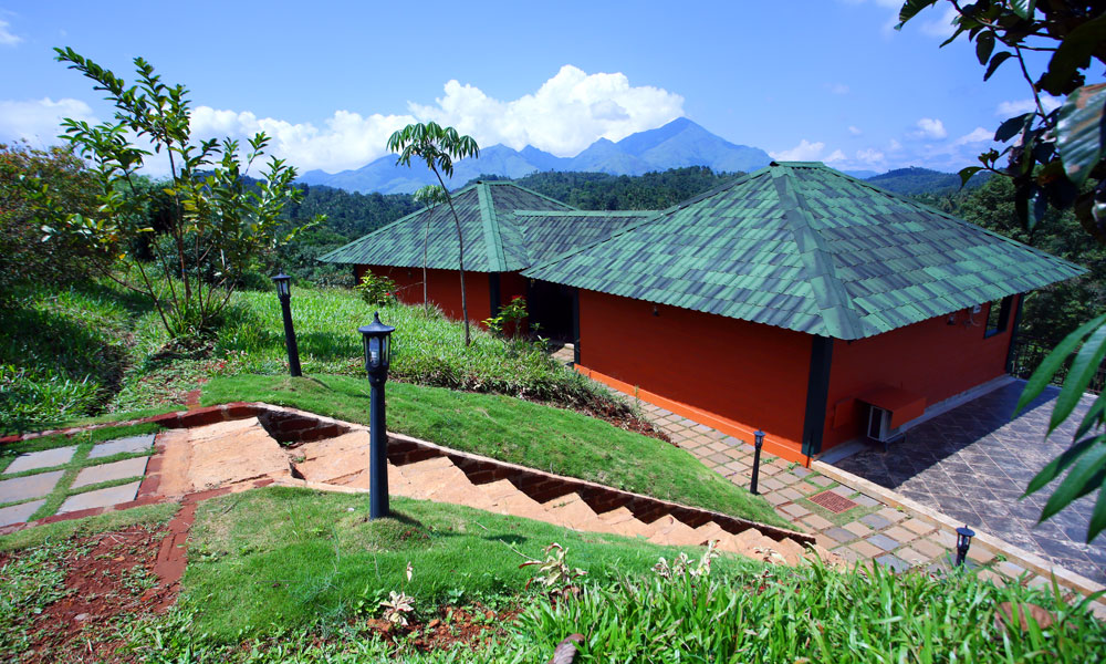Heritage green-tiled Kerala cottage